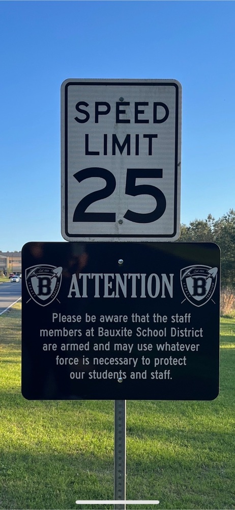 sign about armed staff members 